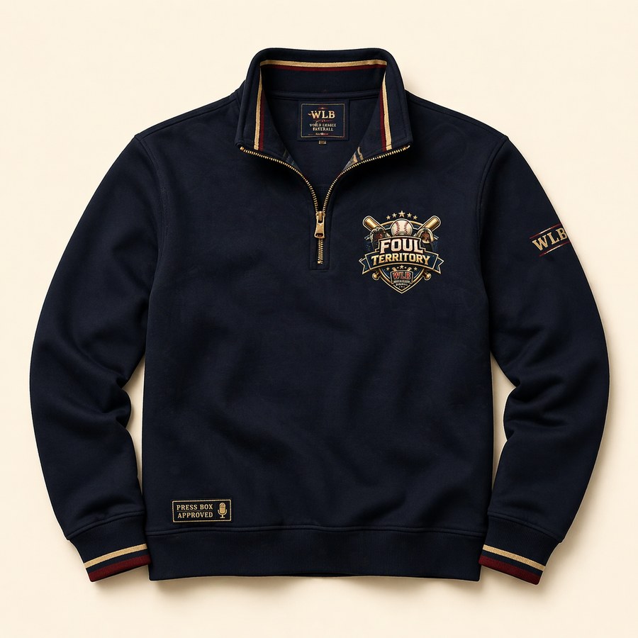 Deep navy quarter-zip pullover with the Foul Territory crest on the chest, a Press Box Approved tag at the hem, and WLB sleeve hit
